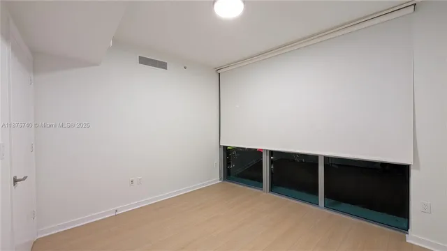 a view of a hallway with a livingroom and a bathroom