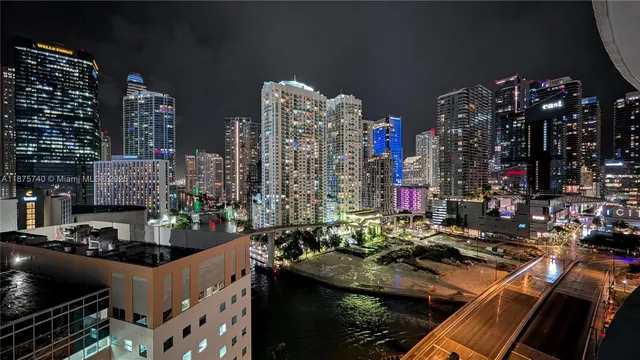 a view of a hallway with entryway and wooden floor