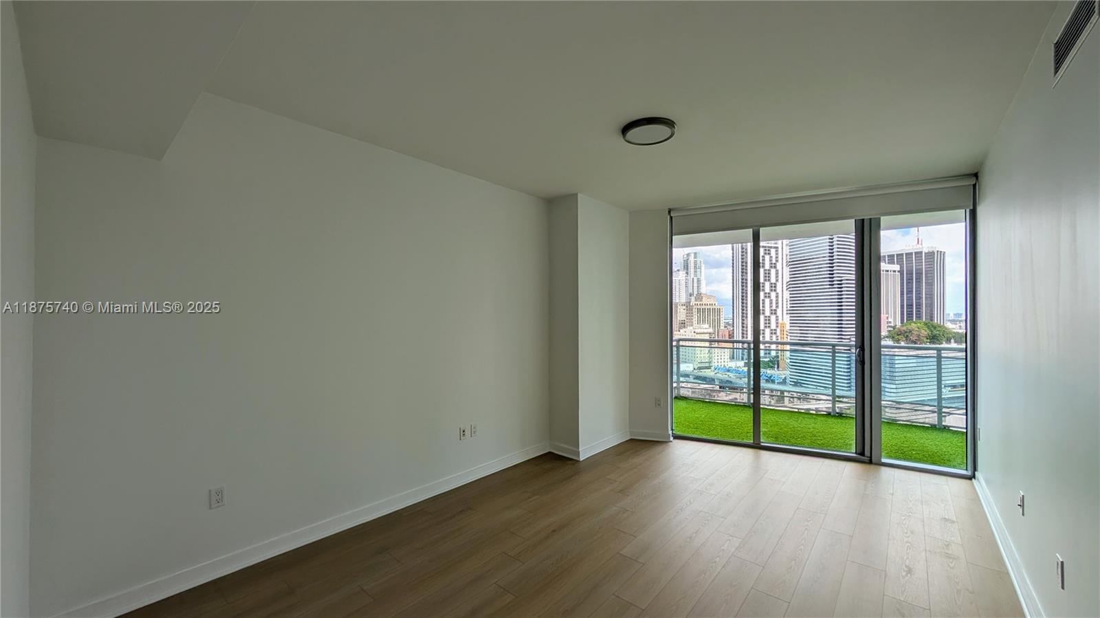 350 South Miami Avenue, Unit 1901 Miami, FL 33130 - Photo 50 of 81 a view of an empty room with wooden floor and a window