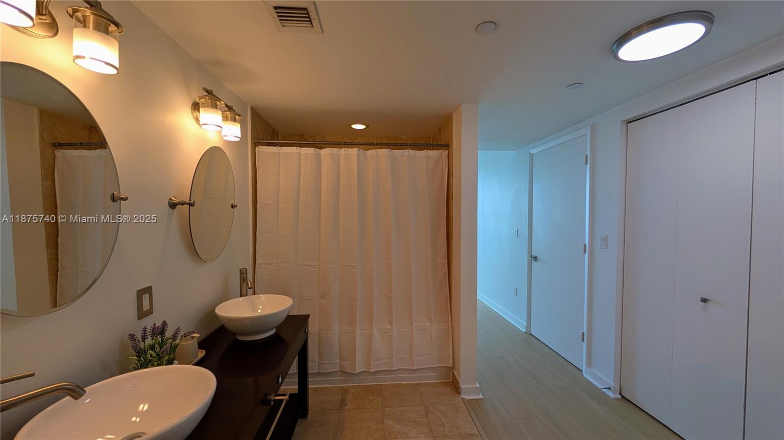 350 South Miami Avenue, Unit 1901 Miami, FL 33130 - Photo 52 of 81 a bathroom with a sink toilet mirror and shower