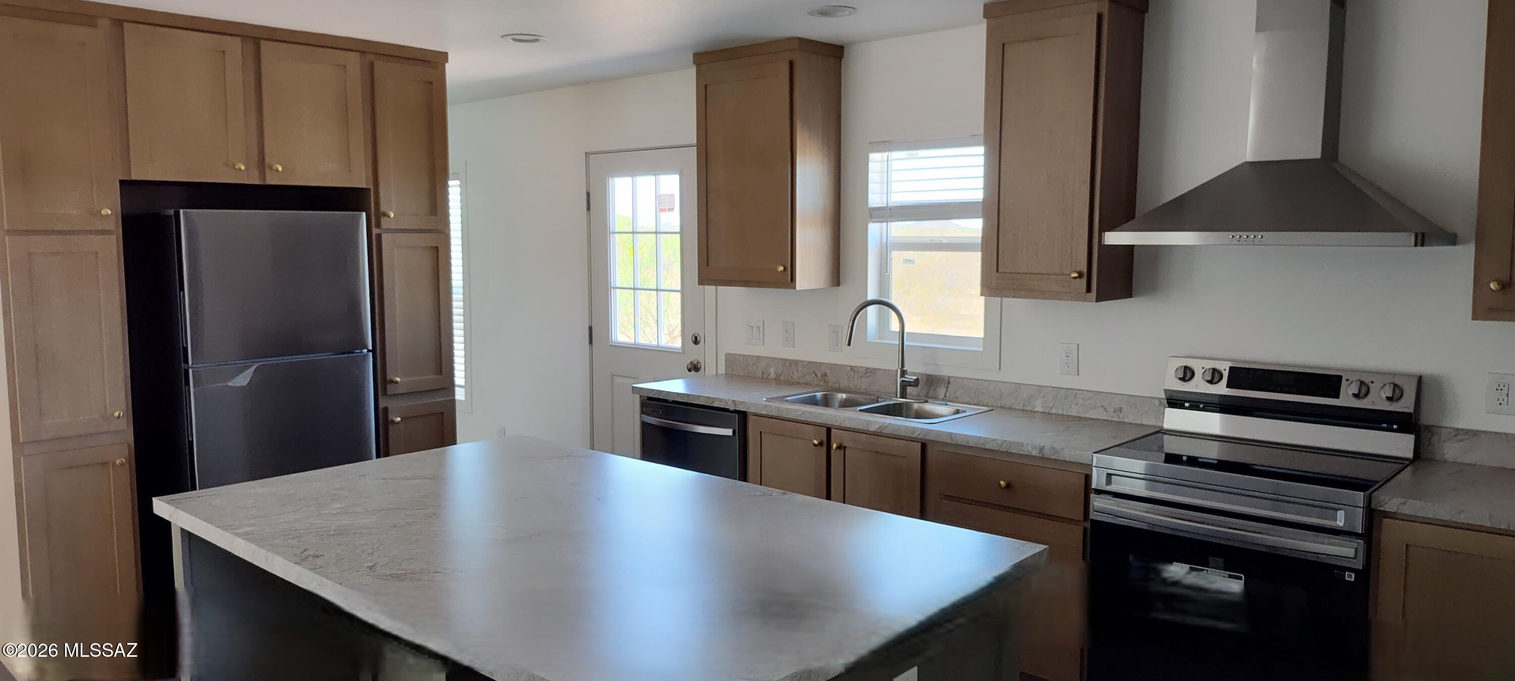 18565 West McClean Road Marana, AZ 85653 - Photo 11 of 37 a kitchen with stainless steel appliances granite countertop a sink a stove and refrigerator