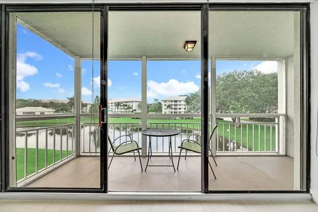 a view of a porch with a floor to ceiling windows