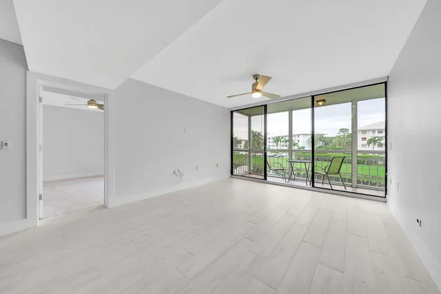 a view of an empty room with windows and city view