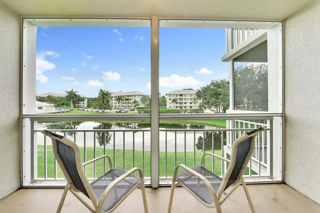 a view of a chair and tables in the balcony
