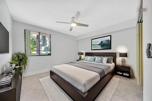 a bedroom with a bed and a potted plant