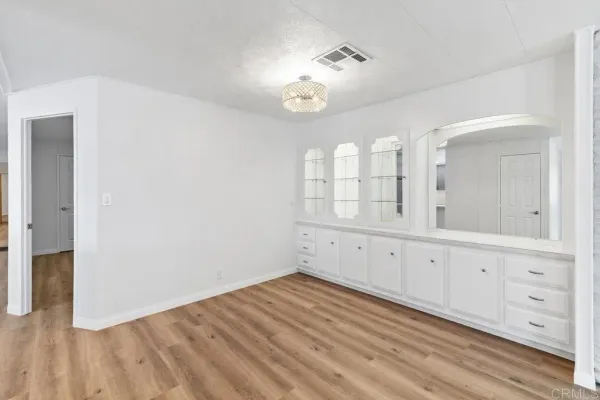 a view of a kitchen with cabinet and mirror