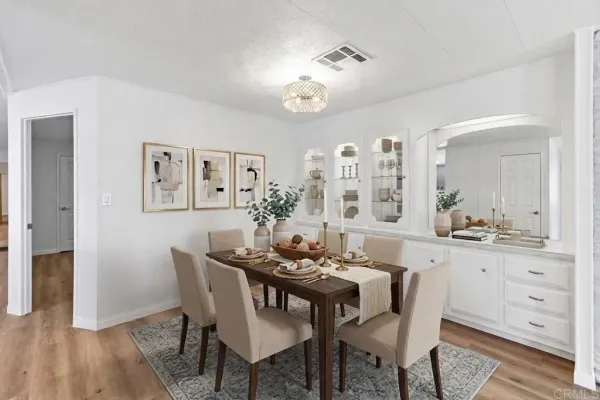a view of a dining room with furniture and wooden floor
