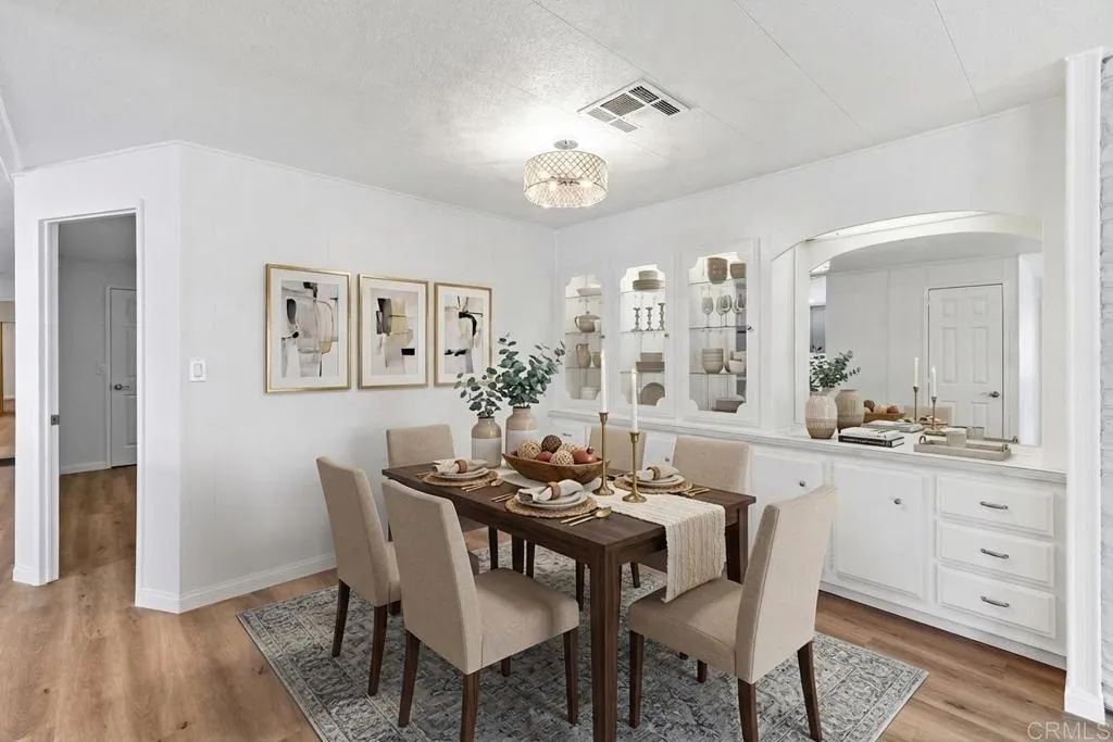 7467 Mission Gorge Road, Unit SPC 10 Santee, CA 92071 - Photo 12 of 44 a view of a dining room with furniture and wooden floor