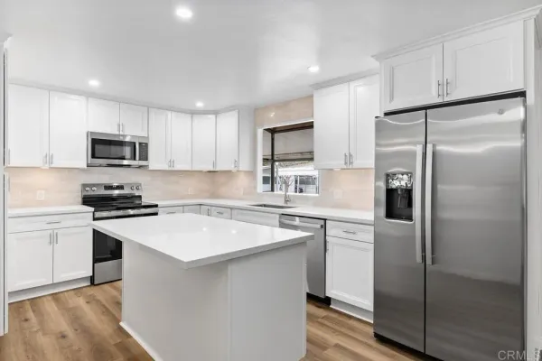 a kitchen with a refrigerator sink and microwave