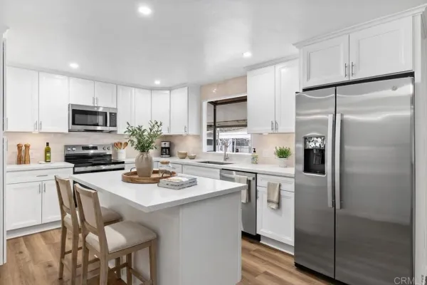a kitchen with a sink cabinets and stainless steel appliances