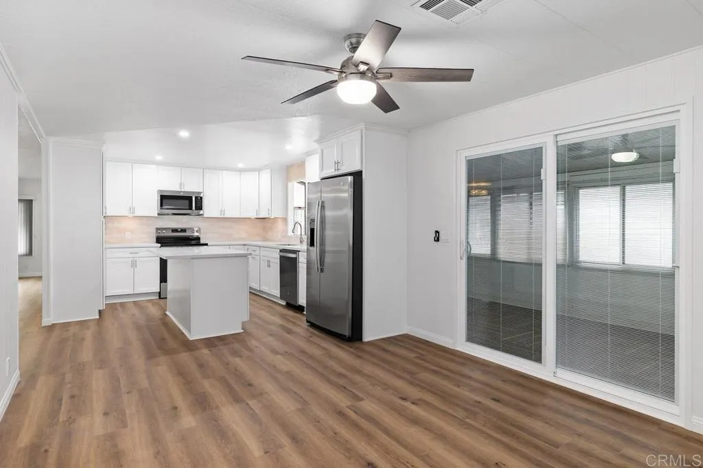 7467 Mission Gorge Road, Unit SPC 10 Santee, CA 92071 - Photo 17 of 44 a kitchen with stainless steel appliances a refrigerator sink and microwave