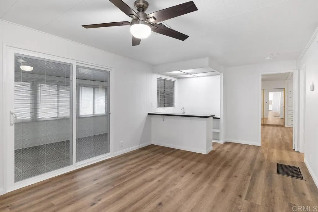 7467 Mission Gorge Road, Unit SPC 10 Santee, CA 92071 - Photo 18 of 44 a view of empty room with wooden floor and fan