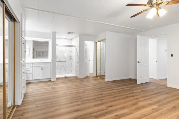 a view of a walk in closet and wooden floor