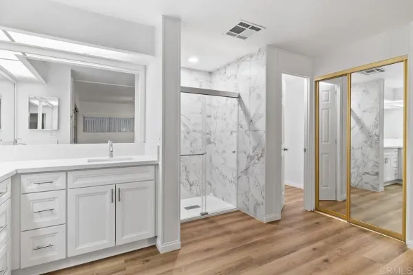 a view of a room with wooden floor and white walls