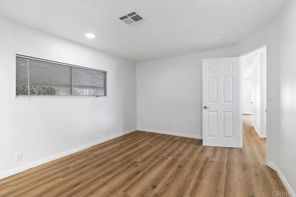 7467 Mission Gorge Road, Unit SPC 10 Santee, CA 92071 - Photo 27 of 44 a view of a room with wooden floor and white walls