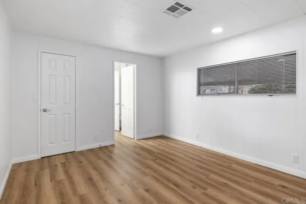 a bedroom with a large bed and a potted plant