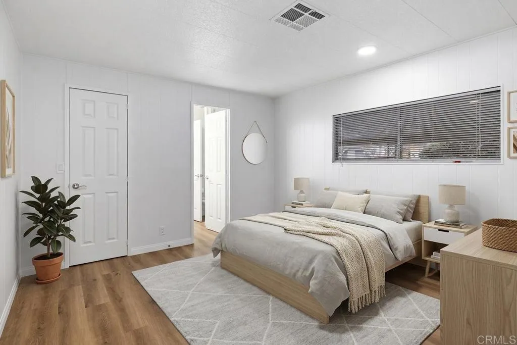 7467 Mission Gorge Road, Unit SPC 10 Santee, CA 92071 - Photo 29 of 44 a bedroom with a large bed and a potted plant