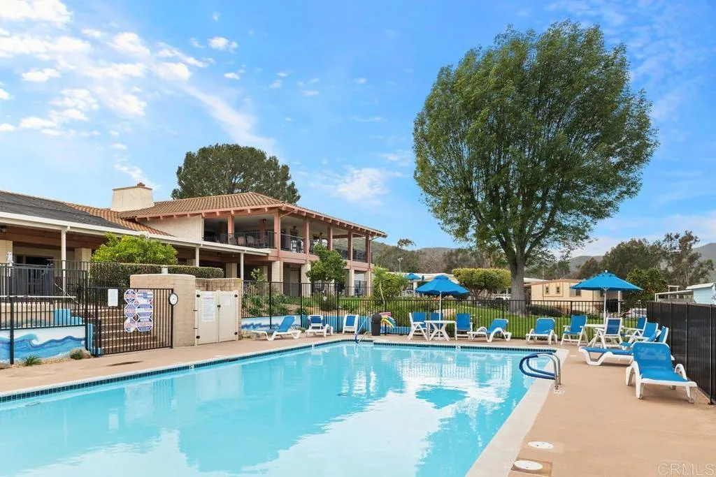 7467 Mission Gorge Road, Unit SPC 10 Santee, CA 92071 - Photo 40 of 44 a view of a swimming pool with a patio and a garden