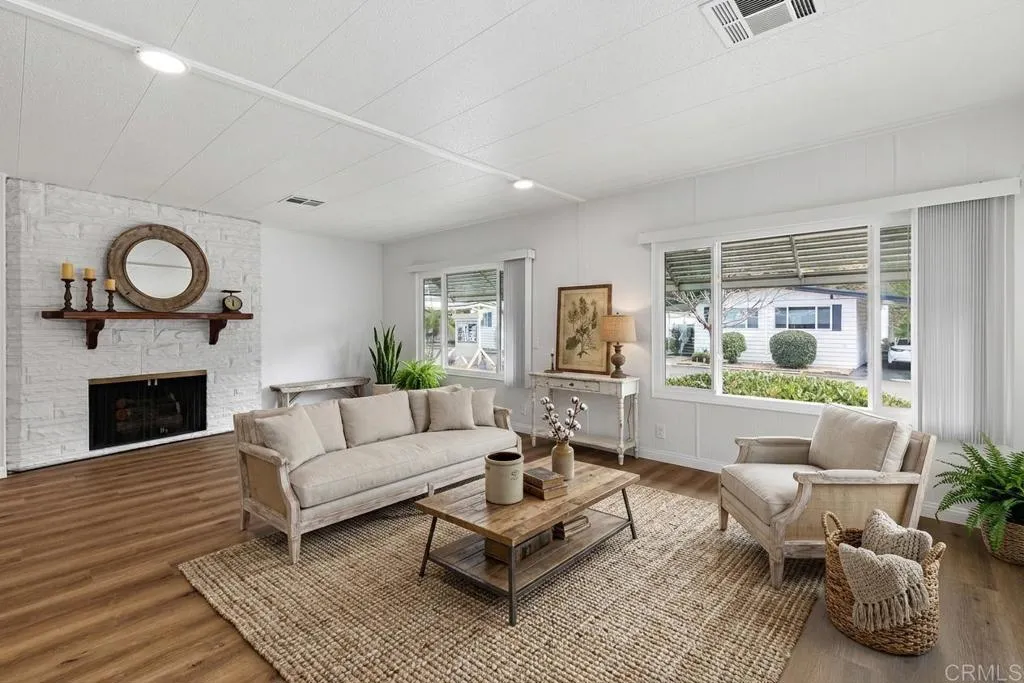7467 Mission Gorge Road, Unit SPC 10 Santee, CA 92071 - Photo 7 of 44 a living room with furniture a fireplace and a large window