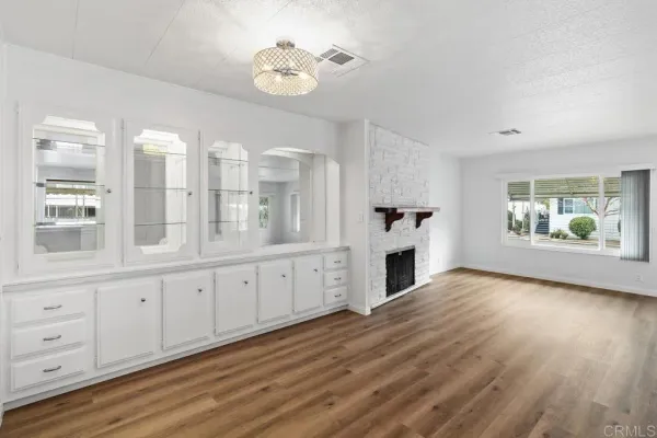 a view of a kitchen with wooden floor and windows