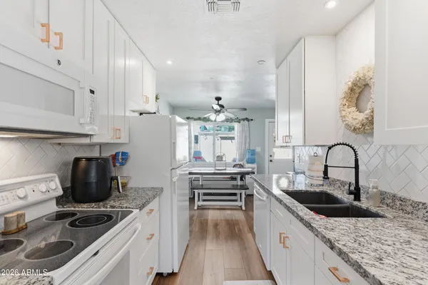 a kitchen with kitchen island stainless steel appliances a sink stove and cabinets