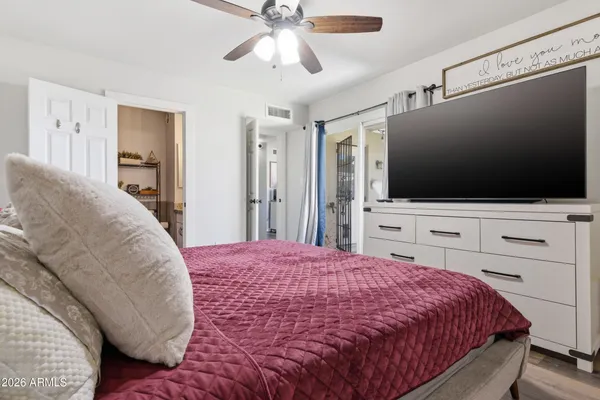 a bedroom with a bed and a flat screen tv