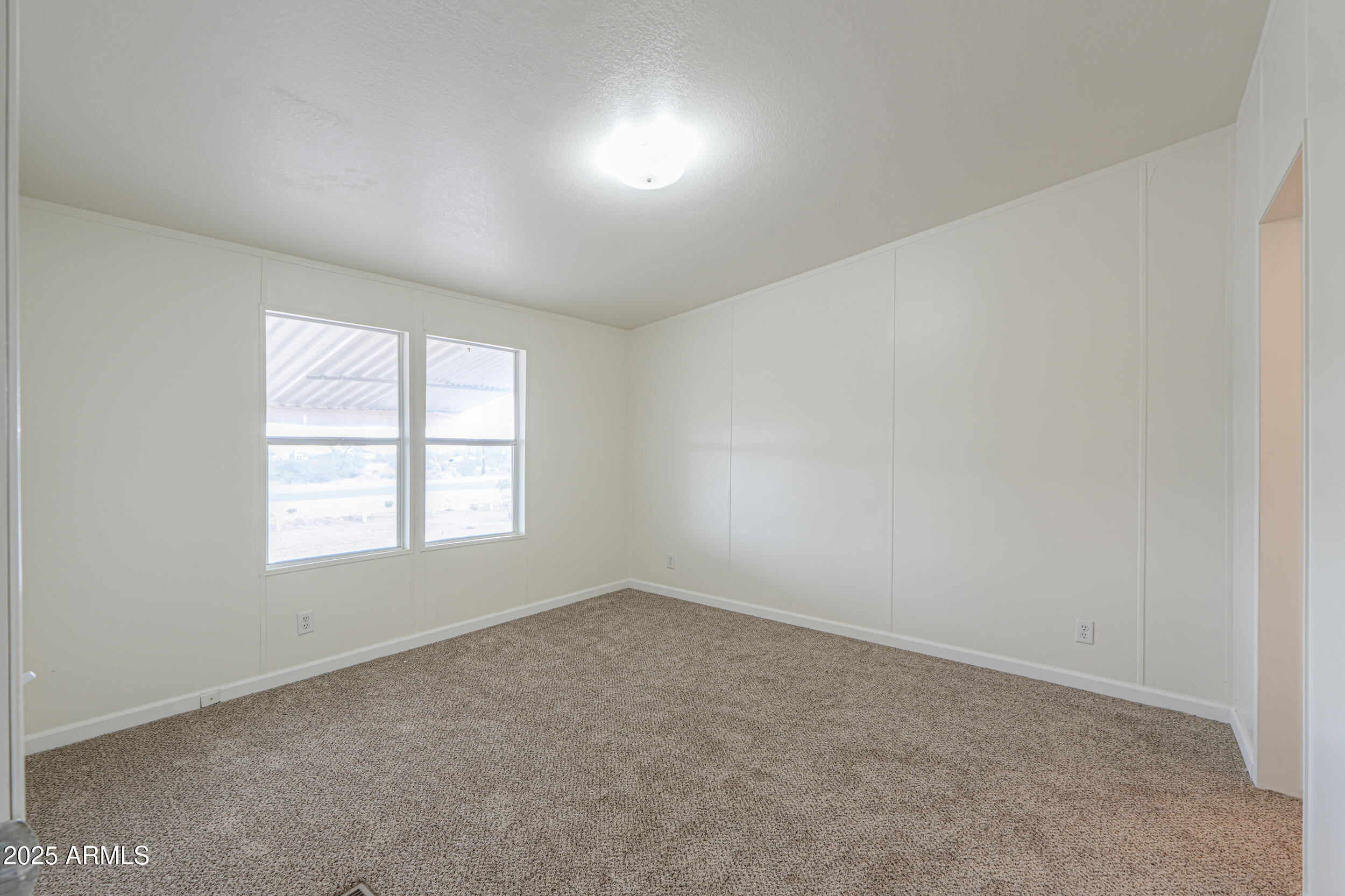 270 North Ralston Road Maricopa, AZ 85139 - Photo 44 of 75 an empty room with a window