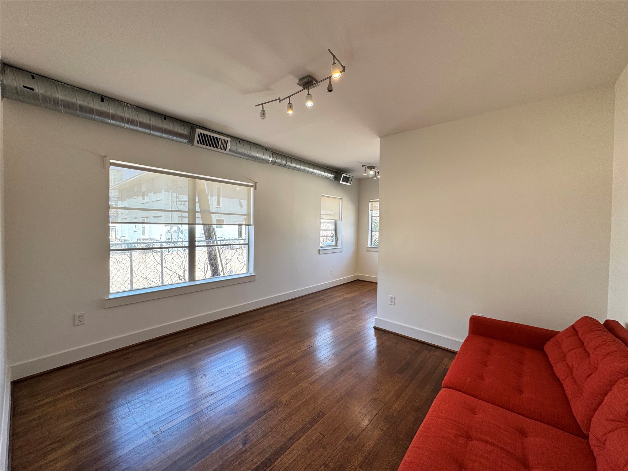 1509 Holman Street, Unit 2 Houston, TX 77004 - Photo 3 of 10 a living room with furniture and a large window