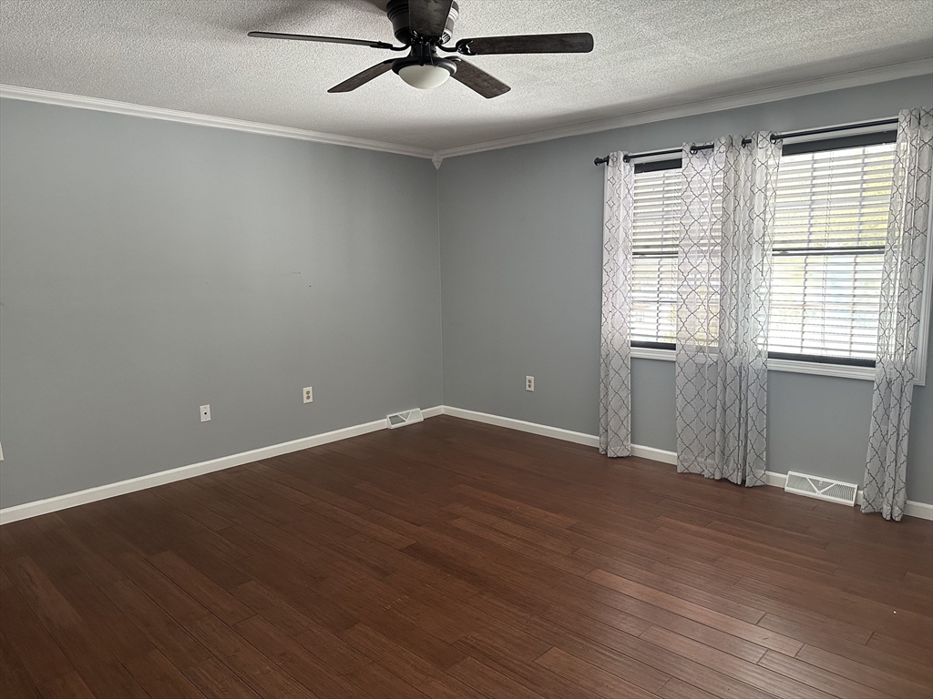 54 Old Fuller Rd Extension Chicopee, MA 01020 - Photo 18 of 25 an empty room with wooden floor fan and windows