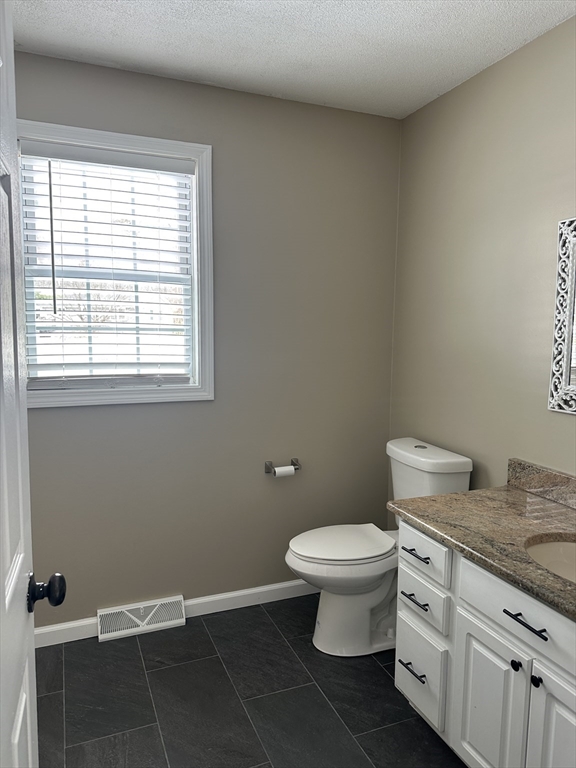 54 Old Fuller Rd Extension Chicopee, MA 01020 - Photo 24 of 25 a bathroom with a granite countertop toilet and a sink