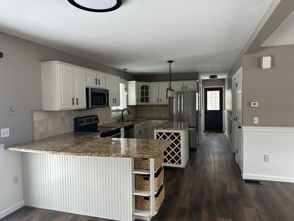 54 Old Fuller Rd Extension Chicopee, MA 01020 - Photo 7 of 25 a kitchen with stainless steel appliances granite countertop a sink refrigerator and microwave