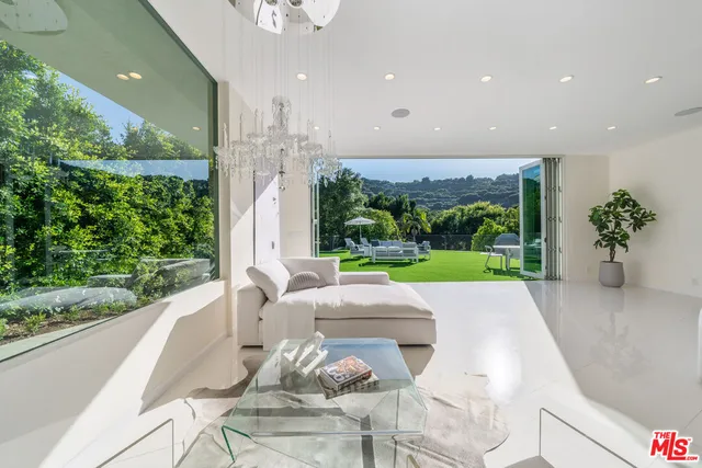 a patio with table and chairs and potted plants