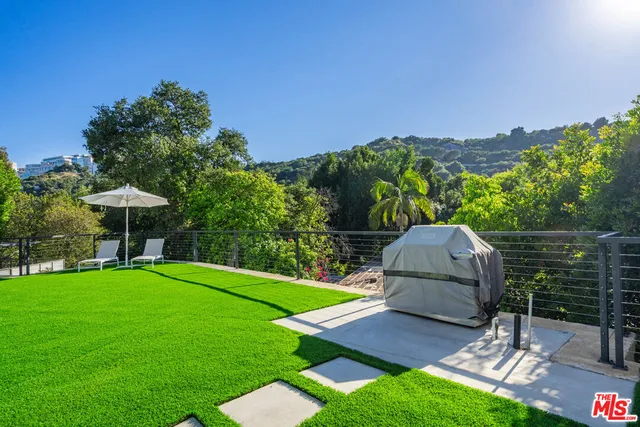 a view of a backyard with sitting area
