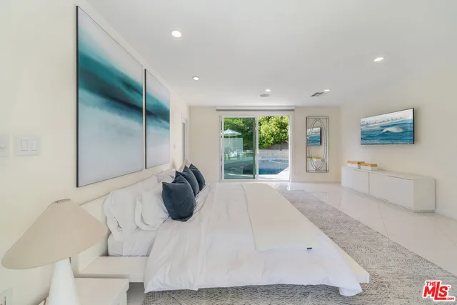 a large white bed in a white room