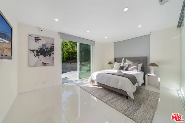 a bedroom with a large bed and a large window