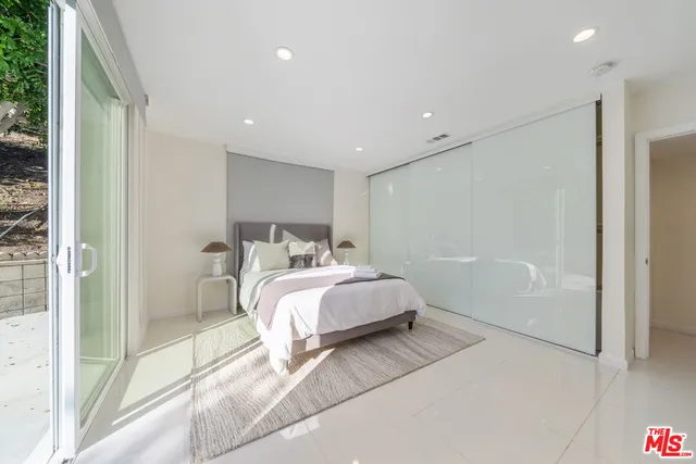 a spacious bedroom with a bed and a shower