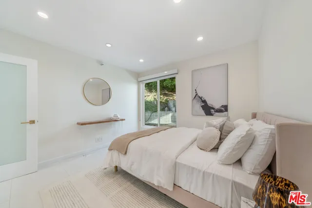 a bedroom with a large bed and a window