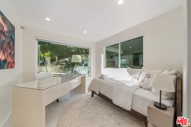 a bed room with a bed and a large window