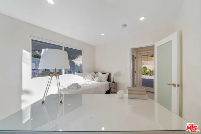 a bedroom with a bed and a mirror