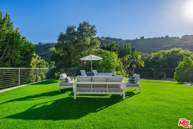 a view of a garden with an outdoor seating