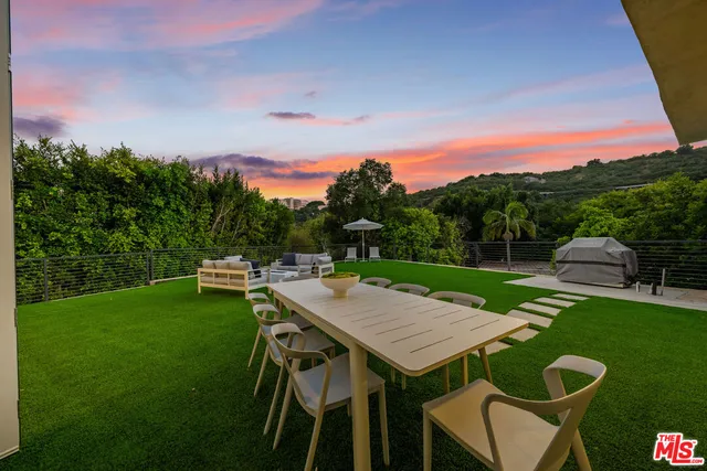 a view of a dinning table and chairs on the deck