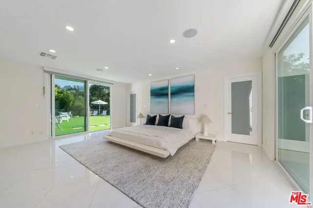 a living room with a bed and large window