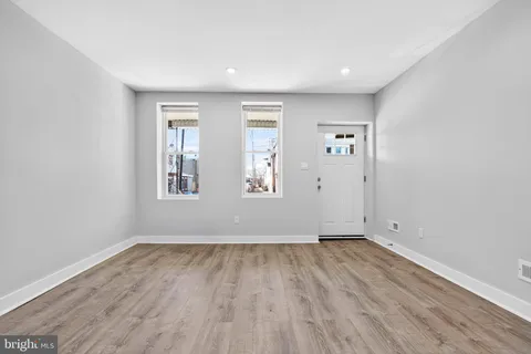 a view of a kitchen with a sink and wooden floor