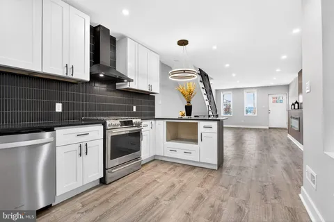 a view of a hallway with wooden floor and closet