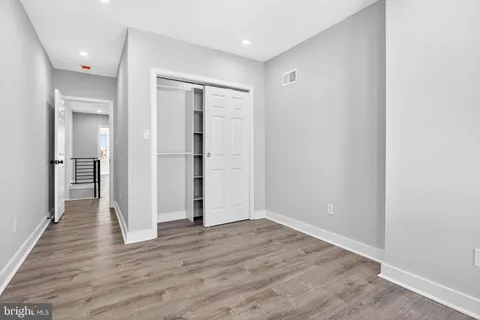 an empty room with wooden floor and a window