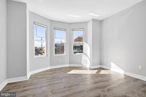 an empty room with closet and wooden floor