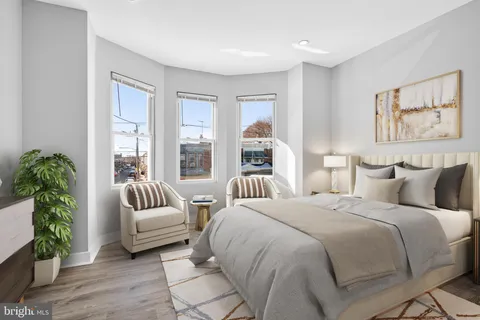 a spacious bedroom with a bed and a couch