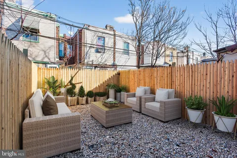 a view of a patio with couches and potted plants