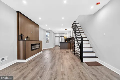a view of a kitchen with a hallway to a house and a fireplace