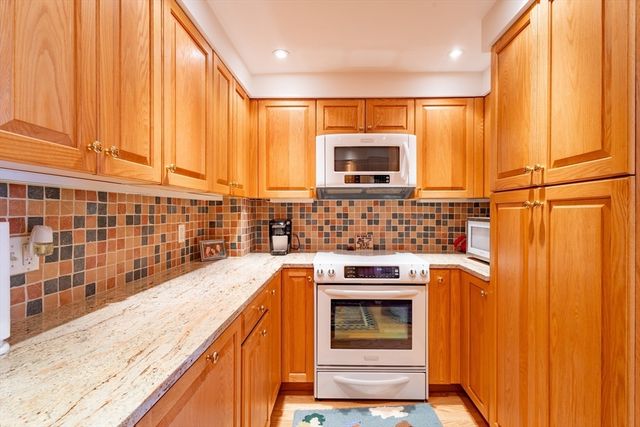 a kitchen with stainless steel appliances a stove a sink and a microwave